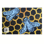 Limited edition hand-made print of black and white Bees on a honey gold hive pattern